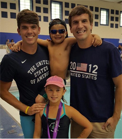 Charlie Houchin with swimmers at a meet